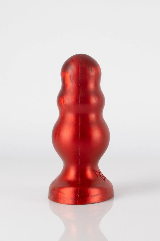 A side photo of a red bubble butt plug.
