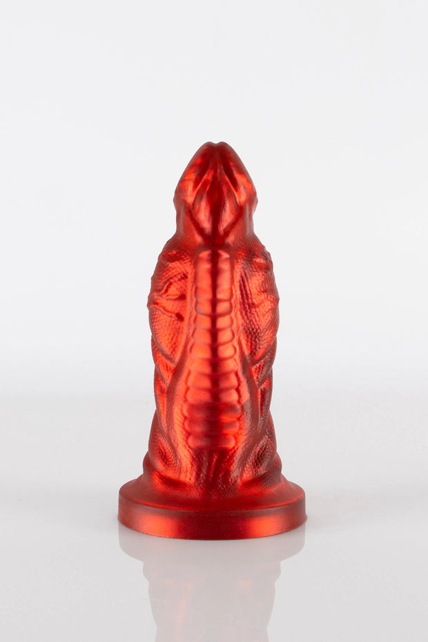 A product photo of a red demon dildo taken from the front showing off the toy&